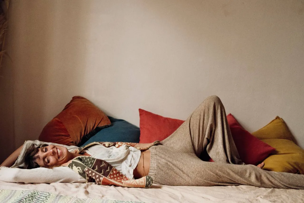 Rest and ease, laughter softening the body into presence.