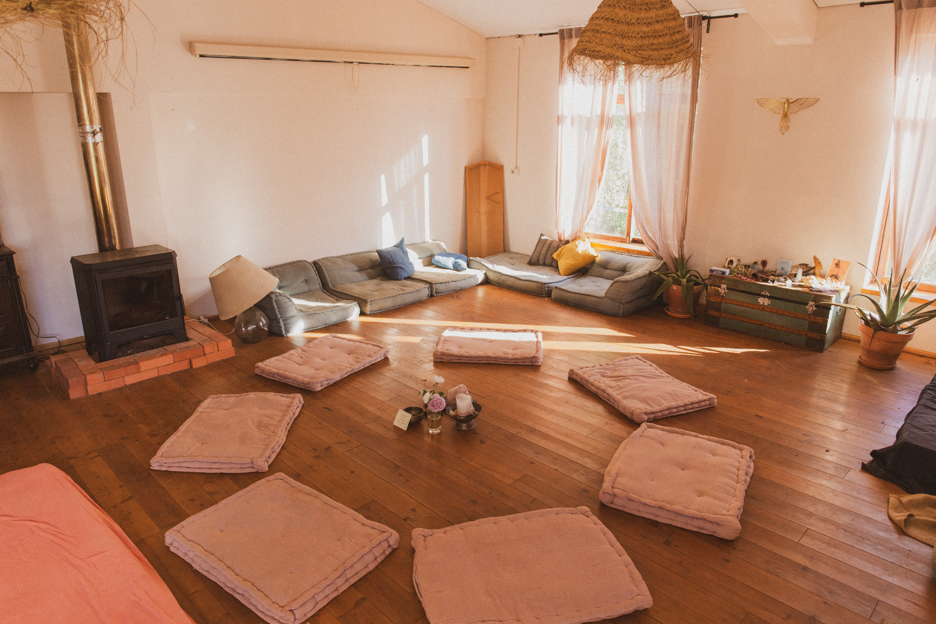 A gathering space at Mosaic, cushions arranged on a wooden floor